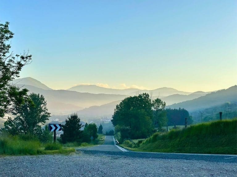 A road curving with mountains on the horizon