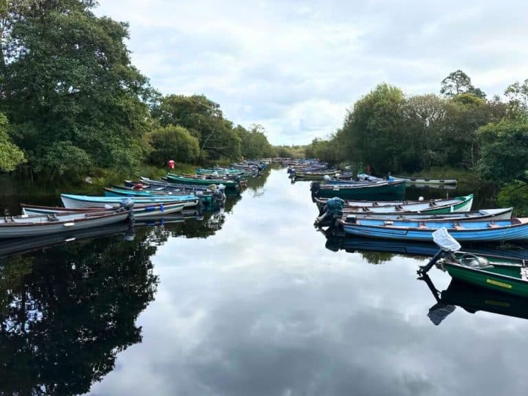Boats lined up on a quiet canal in Southwest Ireland.
