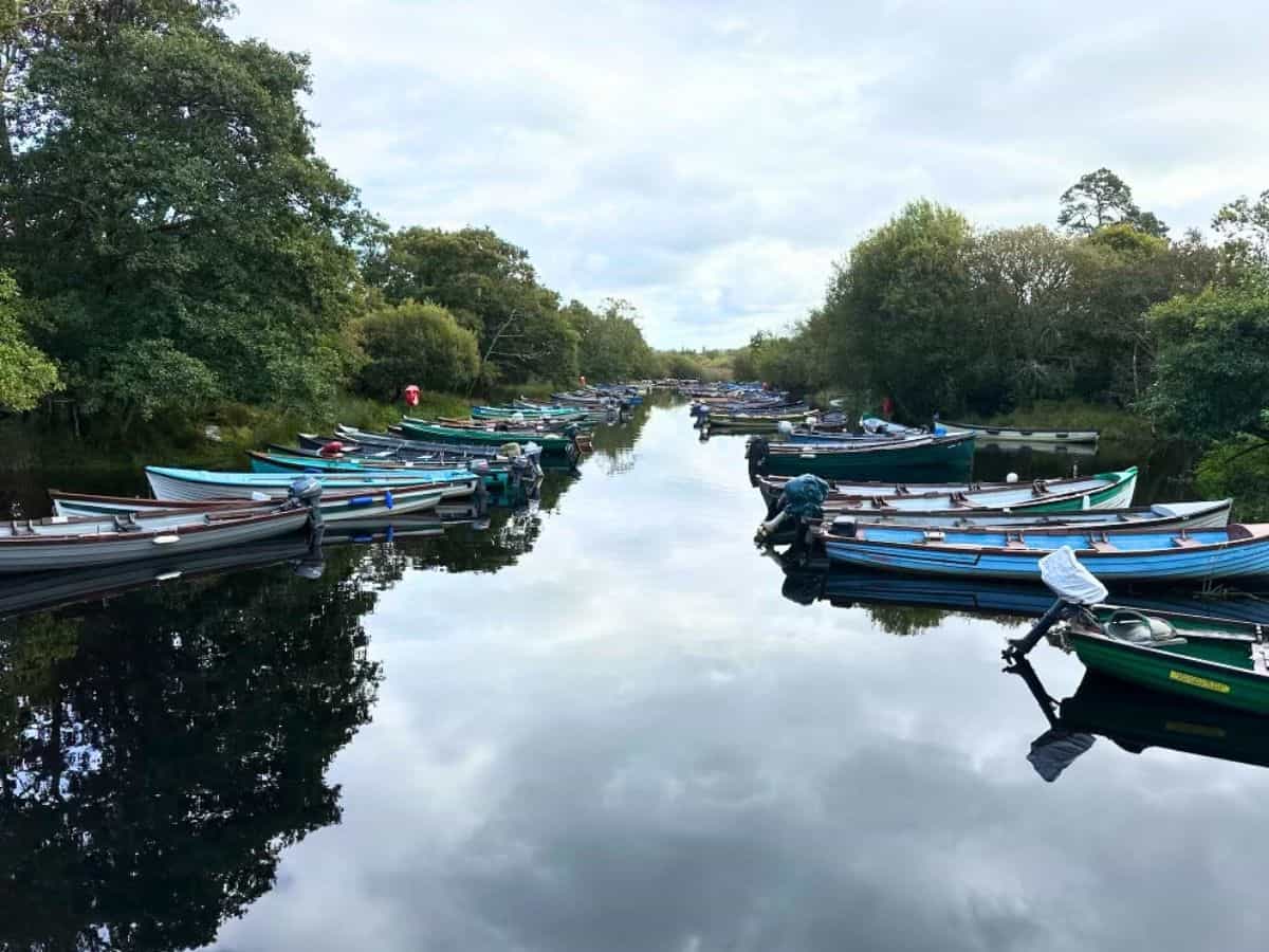 Boats lined up on a quiet canal in Southwest Ireland.